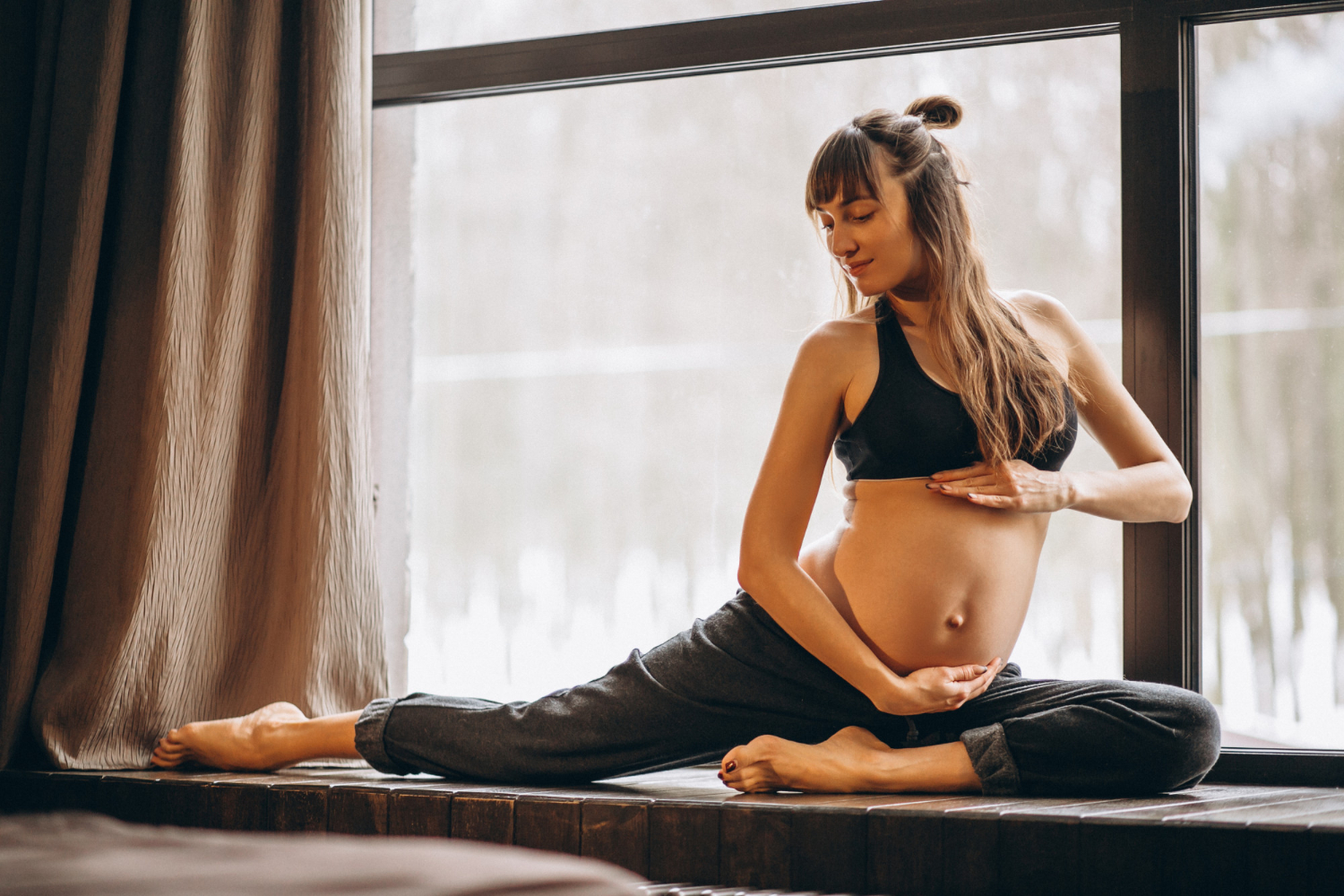 A pregnant girl stretching 
