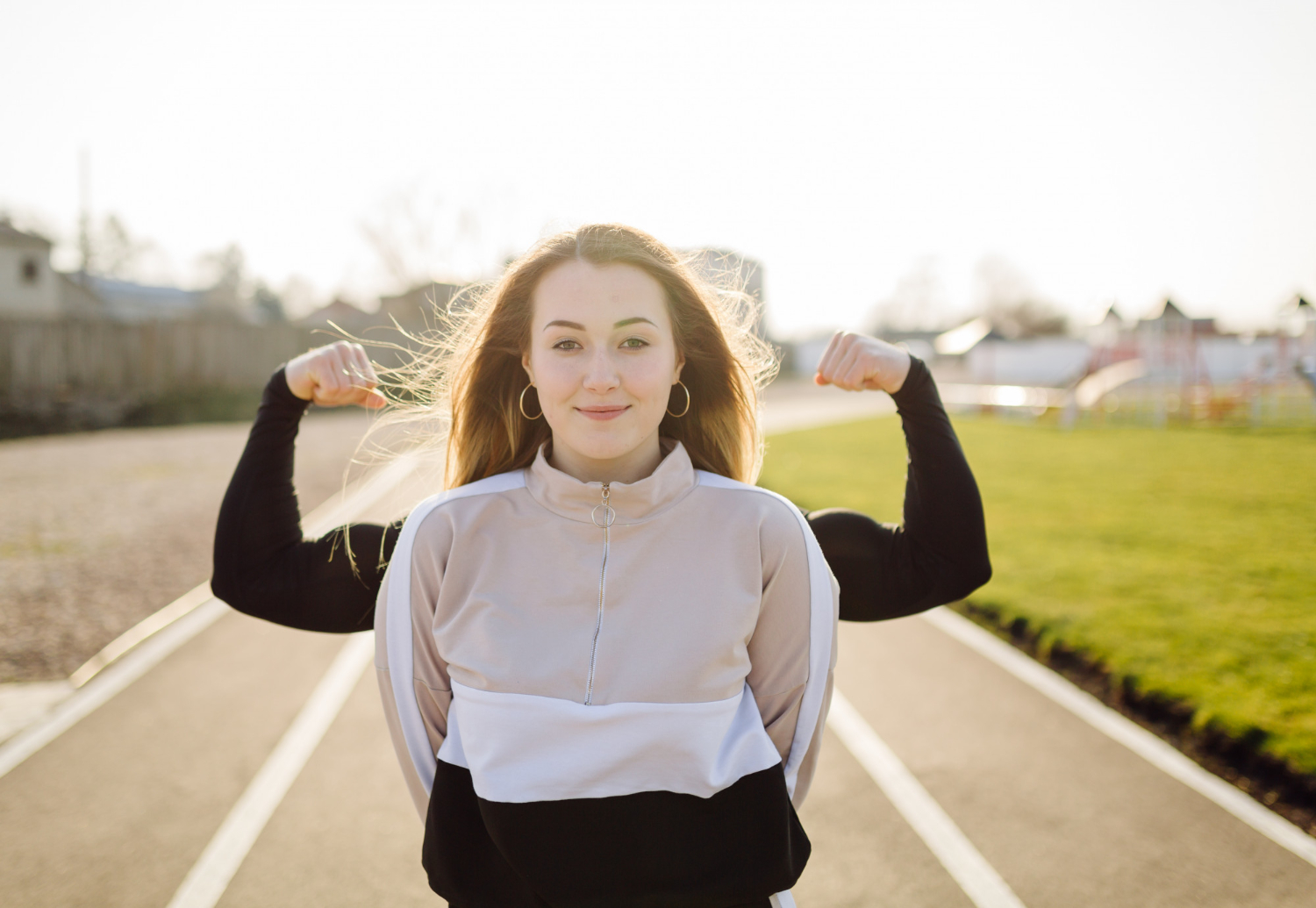 Girl walks on a street with strong arms behind