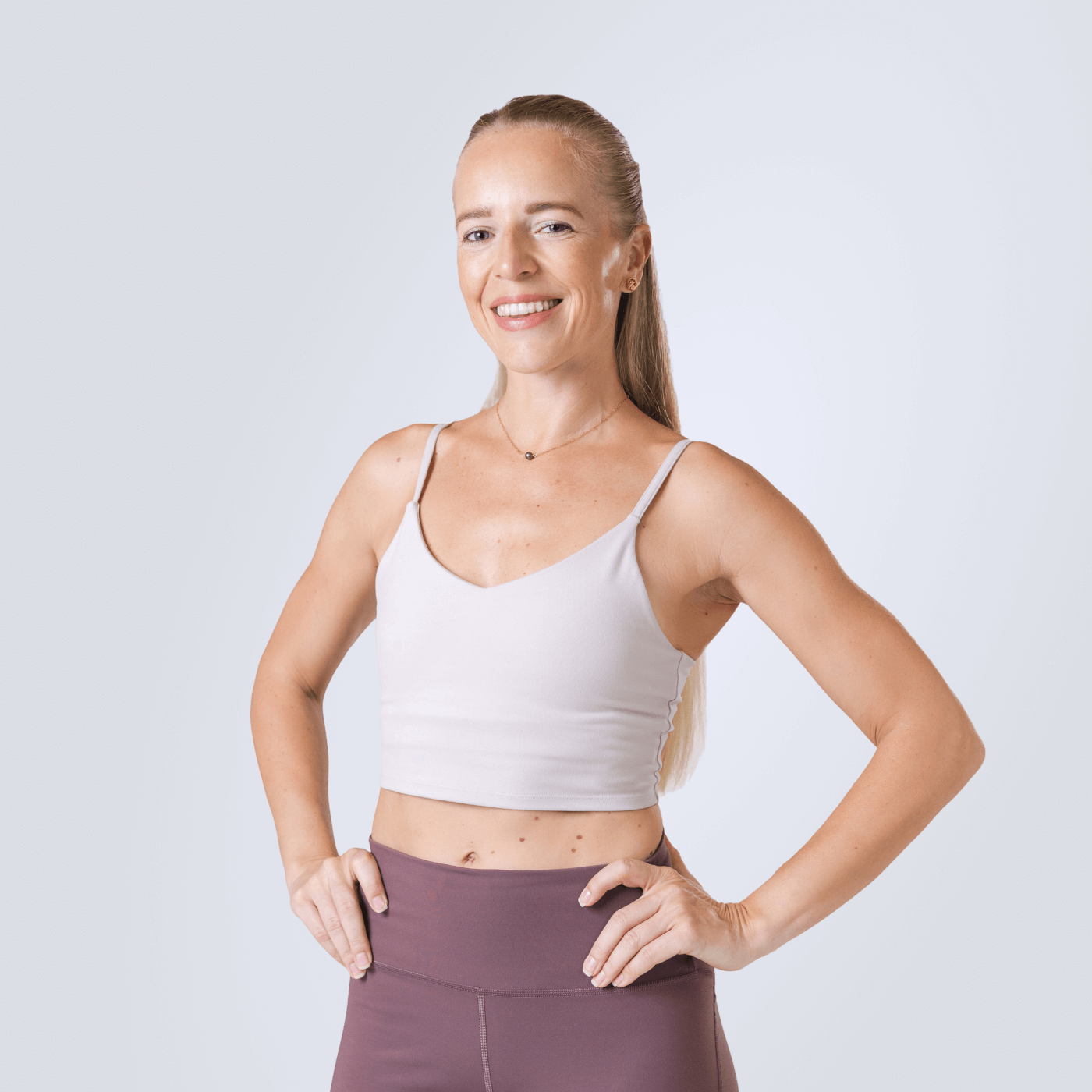 Girl is sitting on a fitness mat